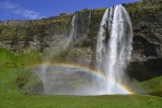 Seljalandsfoss Wasserfall in Sommer mit einem Regenbogen und gr�nen Gras